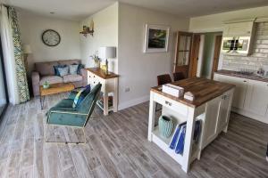 a living room with a couch and a table at Gleann Ciuin in Ballymartin