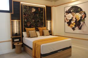 a bedroom with a bed with a large painting on the wall at Promotur Suites - Ayora in Valencia