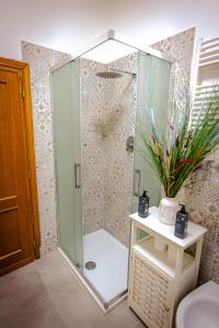 a shower with a glass door in a bathroom at Florence Garden Suite in Florence