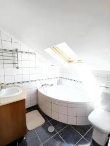 a bathroom with a tub and a toilet and a sink at 3 bedrooms villa with private pool furnished garden and wifi at Segoes 