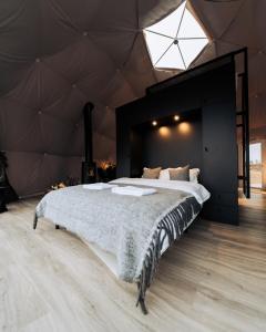 a bedroom with a large bed in a tent at Golden Circle Domes - Lake View in Selfoss