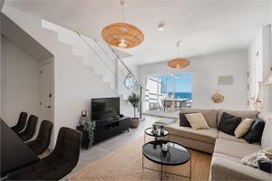 a living room with a couch and a tv at Stunning Duplex with Sea Views in Gran Alacant