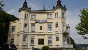 a large yellow building with a sign on it at Trip Inn Parkhotel Bad Ems in Bad Ems