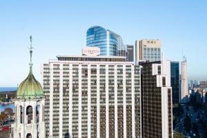 a building with a clock tower in front of a city at Sheraton Buenos Aires Hotel & Convention Center in Buenos Aires