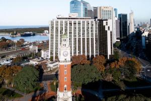 a building with a clock tower in front of a city at Sheraton Buenos Aires Hotel & Convention Center in Buenos Aires