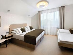 Ένα ή περισσότερα κρεβάτια σε δωμάτιο στο Hotel Lomnica