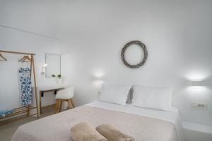 a bedroom with a bed with a mirror and a desk at Spectacular view Caldera St V in Megalochori