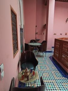 a room with chairs and a table and tables at Dar Mchachti fes in Fez