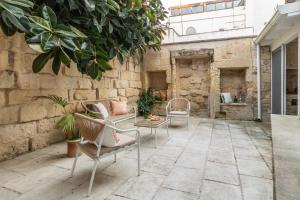 a patio with two chairs and a table at Il Giardino dei Mesagnesi - Lecce Selection in Lecce