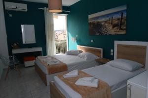 a hotel room with two beds and a television at Stef & Stam Nerantzis in Himare
