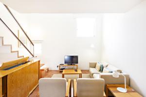 a living room with a couch and a tv at Convento das Bernardas by MY CHOICE in Tavira