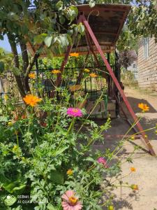 a garden with flowers and a gazebo at Lerik Vista House in Lerik
