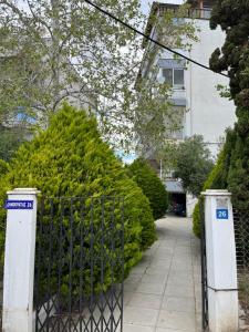 a gate in front of a building with bushes at Studio by the sea Perea in Perea