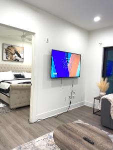 a room with a tv on a wall next to a bed at 45 William st Newark NJ in Newark