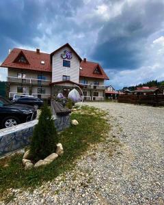 a house with a tree in front of a building at Whiteberry Studio in Bukovel