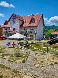 a large house with a fence in front of it at Whiteberry Studio in Bukovel