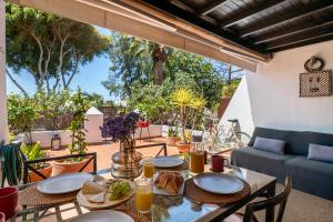 a table with plates of food on a patio at Casa La Rosa Del Mar in Costa Teguise