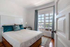 a bedroom with a bed and a large window at Casa La Rosa Del Mar in Costa Teguise