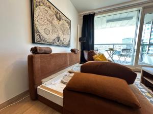 a living room with a couch and a large window at Self check-in, Danube bank, free parking in Bratislava