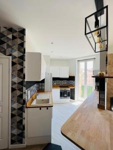 a kitchen with white cabinets and black and white tiles at Joyau rare port de Nice in Nice +18 photos