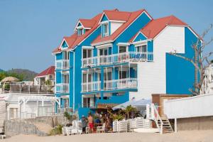 a blue and white building on the beach at Splendide appartement sur la plage de Grand Case in Grand Case