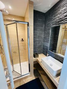 a bathroom with a shower and a sink at Joyau rare port de Nice in Nice