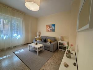 a living room with a couch and a table at New apartment next to the sea in Bordighera