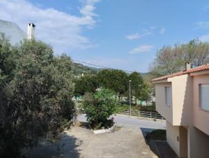 a view of a street with trees and a building at Dimitras apartment in Paleo Tsifliki