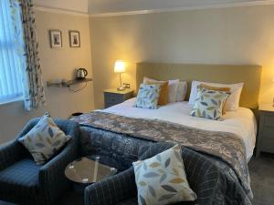 um quarto de hotel com uma cama e um sofá em Cornerways Llandudno em Llandudno