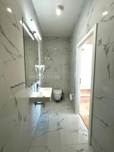 a bathroom with a sink and a toilet at Štupartská - Attic Old Town Residence in Prague +53 photos