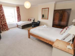 a bedroom with two beds and a window at Jubilee House in Alnwick
