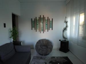 a living room with a couch and a chair at Dimitras apartment in Paleo Tsifliki