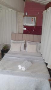 Uma cama ou camas num quarto em Apêzinho Vidigal - RJ
