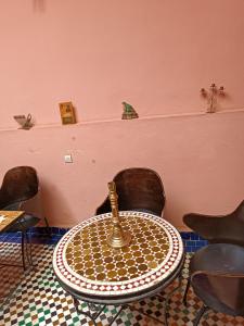 a room with a table and two chairs and a table at Dar Mchachti fes in Fez
