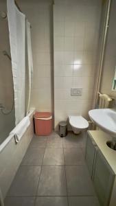 a bathroom with a tub and a toilet and a sink at 111 Stylish apartment in the city center quiet area in Lausanne