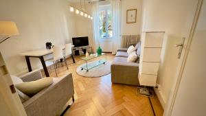 a living room with a couch and a table at 111 Stylish apartment in the city center quiet area in Lausanne