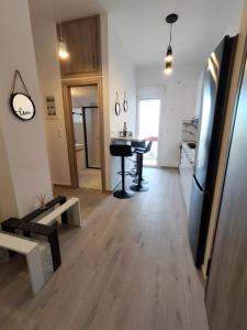 a living room with a table and a kitchen at Luxury sea apartment in Loutraki