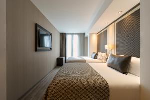 a hotel room with two beds and a television at Catalonia Square 4* Sup in Barcelona +39 photos