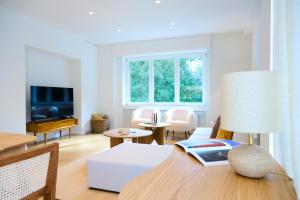 a living room with a couch and a tv at The Nations Bois de la Cambre Flats in Brussels