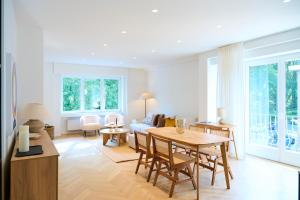a living room with a table and a couch at The Nations Bois de la Cambre Flats in Brussels