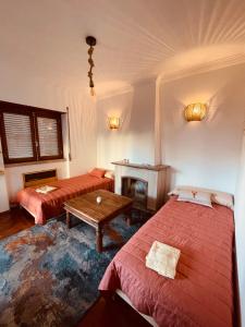 a room with two beds and a table and a fireplace at Lisbon Soul Surf Camp in Cascais