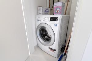 a washer and dryer sitting in a laundry room at JTower - Magical Apartments In City Center in Jerusalem