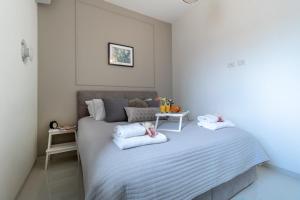 a bedroom with a bed with two pillows on it at JTower - Magical Apartments In City Center in Jerusalem