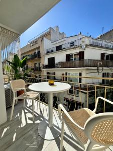 a patio with a table and chairs on a balcony at Aldara Sitges in Sitges