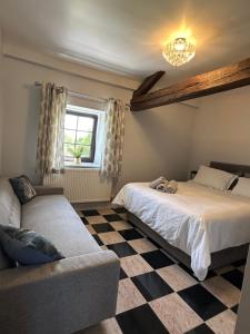 a bedroom with two beds and a couch at Chambres d'hôtes du Vigeant in Le Vigeant +28 photos