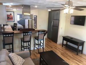 a living room with a kitchen and a bar with stools at Entire apartment close to downtown - 2 Queen beds in Springfield
