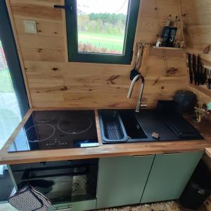 a kitchen in a tiny house with a sink at Tipi Apache des monteaux in Vivy