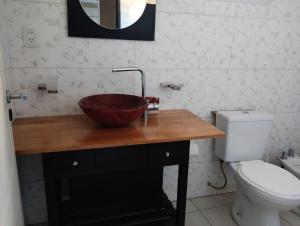 a bathroom with a sink and a toilet at Complejo calle Cordoba in General Roca