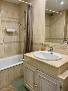 a bathroom with a sink and a tub and a shower at SOLGUEST APARTAMENTO II NAPOLEÓN vistas espectaculares!!! in Marbella