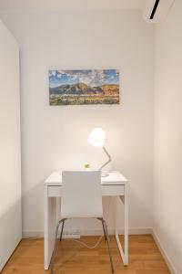una scrivania bianca con sedia e un dipinto sul muro di MAD COCO Aparts & Suites Sol Temporada a Madrid